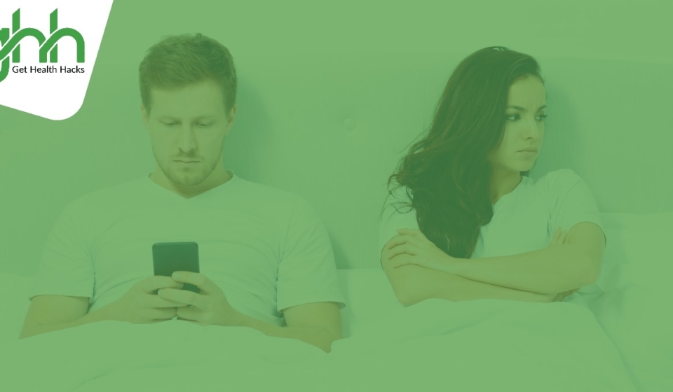 Image shows a common relationship problem that a man is using a mobile phone and a woman lying in the bed turning her face and feeling annoying.